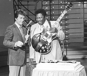 1975: Dick Clark interviewing famous blues guitarist, B.B. King, with what appears to be a birthday cake.