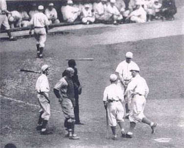 A’s Al Simmons crossing home plate during the 10-run 7th inning of game 4 in the ‘29 Series. Jimmie Foxx, facing out, awaits his turn to hit.