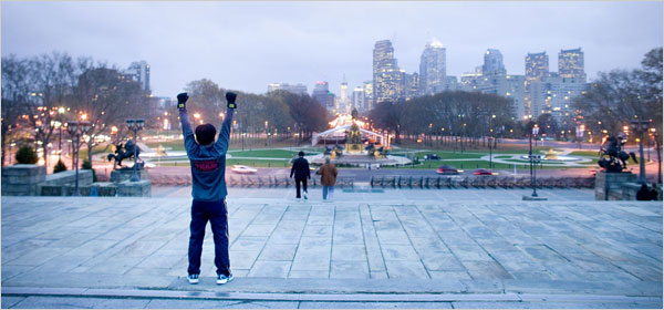 A Philadelphia jogger does a ‘Rocky’ imitation on the steps of the Philadelphia Art Museum looking out on center city, November 2006.  Photo, Ryan Donnell, New York Times. Click for assortment of Rocky Balboa wall art.