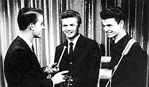Dick Clark interviewing the Everly Brothers at a “Bandstand” performance. They appeared at least twice in 1957 – Sept 13th & Dec 23rd, singing “Wake Up Little Susie” and other songs.