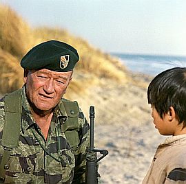 John Wayne with young Vietnamese boy, Hamchunk, in part of final scene from 1968 film, The Green Berets.
