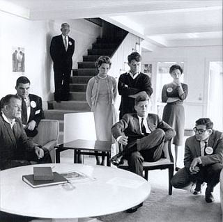 Nov. 1960: JFK & aides watching returns on TV after the election. From left: artist Bill Walton, Pierre Salinger, unidentified man on stairs, Ethel Kennedy, Robert Kennedy, Jack Kennedy, RFK. secretary Angie Novello, and campaign aide Bill Haddad.  Photo, Jacques Lowe.