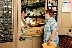 Yvonne Rennolds stops by the Arrow Rock, Arkansas post office in August 2011 to get her mail and bring postmaster Tempe McGlaughlin a container of pasta salad. The post office is among those slated for closing.  Sarah Hoffman.