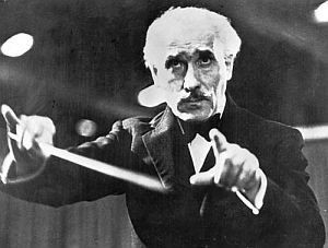 Arturo Toscanini, the famous Italian conductor, at work.