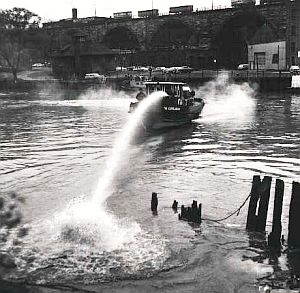 1961: Fireboat on the Cuyahoga River using high-pressure water hoses to clear fire-prone oily build-ups. 