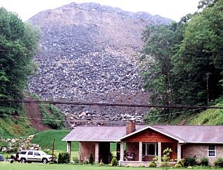 2006: Mountain top strip mining proceeds in the mountains behind a home in Martin County, Kentucky.