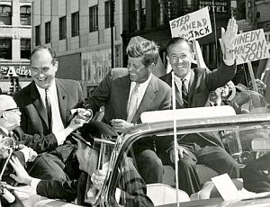 Sept 6, 1960: JFK’s car in Spokane, WA is surrounded by crowds in downtown area as he campaigns with Gov. Albert D. Rosellini (L) and Sen. Henry “Scoop” Jackson (waving), then DNC chairman.