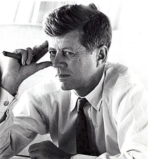 Spring 1960: During the primaries, and traveling aboard ‘The Caroline,” photographer  Jacques Lowe caught Kennedy with one of his “calming props” – here holding a cigar. JFK used cigars, lit and unlit, during conversation and while working on strategy, but mostly in private. He preferred the narrower size, including one favorite, Cuba's Petit Upmann. Click for video vignette.