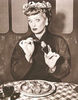 1956: Lucy in French bistro scene from "Paris at Last" episode when she is served escargot by French waiter played by Maurice Marsac. Hilarity ensues when Lucy clamps the snail tongs to her nose, not knowing their purpose. “This food has snails in it,” she exclaims to the insulted waiter, who is then horrified when she says she might be able to eat them with ketchup, close to a French sacrilege.