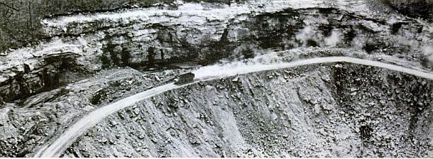 1967:  Life magazine photo of the after-effects of contour strip mining on a Kentucky mountainside showing the highwall cut, coal overburden sent down the hillside, and the remaining shelf, now used as a coal haul road.