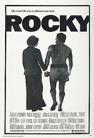 Movie poster of Adrian and Rocky after he has lost the fight, but won the love of his life. Click for Amazon.