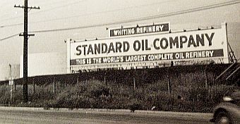 Late 1930s billboard, along a row of storage tanks (behind sign), touting the Whiting refinery as “the world’s largest.”