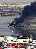 Bouchard Transportation Co. barge burning on Arthur Kill waterway following explosion while unloading gasoline at ExxonMobil depot, Staten Island, NY.