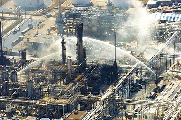 Firefighting water canons are trained on the damaged BP oil refinery in Texas City, TX in the aftermath of March 23rd, 2005 explosion & fire. Fifteen workers were killed and another 180 injured in the disaster. Photo, Brett Coomer/Houston Chronicle.