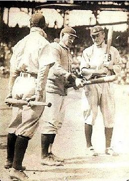 1909 World Series: Honus Wagner at center, Ty Cobb of Detroit at right, and Davy Jones of Detroit with back to camera.