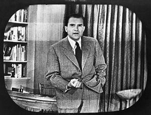 Nixon standing during his televised Checkers speech, when at one point he would say 'I'm not a quitter'.