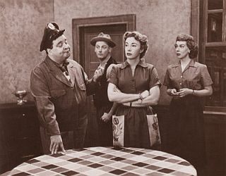 Classic kitchen scene from the ‘Honeymooners’ TV show of the 1950s. From left, Jackie Gleason, Art Carney, Audrey Meadows, and Joyce Randolph. Click for framed photo with program dates.