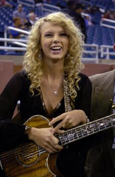 Taylor Swift at Detroit Lions-Miami Dolphins 2006 Thanksgiving Day football game where she sang National Anthem. Photo, Al Messerschmidt / Getty Images