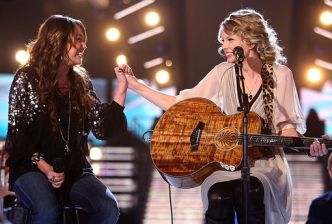 Miley Cyrus and Taylor Swift at conclusion of their duet of ‘Fifteen’ at the Grammy Awards, Feb 2009. Photo, John Shearer/WireImage. 