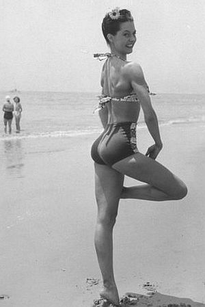Cyd Charisse, 23-year-old ballet dancer and aspiring film star, posing on a Santa Monica beach in September 1945 for Life magazine photographer, Peter Stackpole.