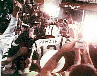 Joe Namath leaving the field of victory following Super Bowl III, January 12, 1969, index finger aloft signifying, "We're No. 1".