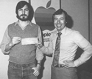 Steve Jobs and Mike Markkula with a check for Apple financing in 1977.