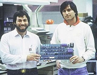 Steve Wozniak and Steve Jobs in 1970s with the mother board of their Apple II computer.