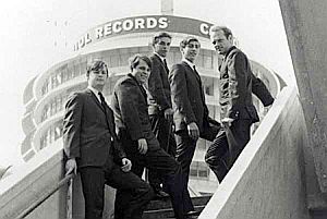Beach Boys shown in early 1960s photo with famous Capitol Records building in Hollywood behind them. They were the first rock group to sign with Capitol in 1962.