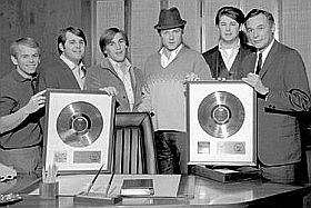 Beach Boys at Capitol Records with president Alan Livingston showing off two gold records, 1964-65.