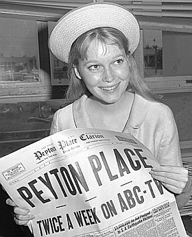 A17 year-old Mia Farrow holding a “Peyton Place newspaper” as she waits for 20th Century Fox TV contract approval in Santa Monica, CA courthouse.  Photo, Los Angles Times, June 17, 1964.