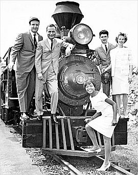 Little Eva shown at front of locomotive engine in 1962 studio promo photo with others, from left: Don Kirshner, Al Nevins, Gerry Goffin and Carole King.