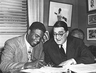 Jackie Robinson & Brooklyn Dodger’s general manager, Branch Rickey, shown in a 1948 photograph. Click for collector plaque.