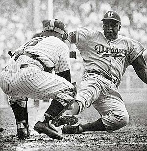 Jackie Robinson’s steal of home in Game 1 of the 1955 World Series still angers Yogi Berra who claims Robinson was out. Photo: Mark Kauffman/SI. Click for related photo.