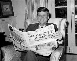 May 1960: John F. Kennedy at home in Washington, D.C. reading newspaper about his victory in the West Virginia primary and rival Hubert Humphrey quitting the race.