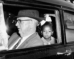 A federal marshal driving first grader Gail Etienne to McDonogh 19 school in New Orleans, November 14, 1960, one of four black children who entered two previously all-white schools in the city. Times-Picayune photo.