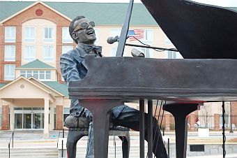 In Ray Charles’ birthplace of Albany, Georgia, a revolving, illuminated, bronze statue of Charles seated at a baby grand piano (by sculptor Andy Davis) is the centerpiece of the Ray Charles plaza and park.