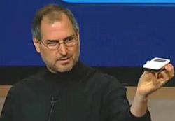 Steve Jobs showing off the thinness of the new iPod music player, October 2001.