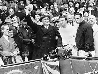 Oct 5 1933:  Franklin D. Roosevelt prepares to throw ceremonial baseball at Griffith Stadium in Washington, D.C. at Game 3 of the 1933 World Series. Directly right of FDR is Washington manager Joe Cronin and New York manager Bill Terry.  AP photo. 