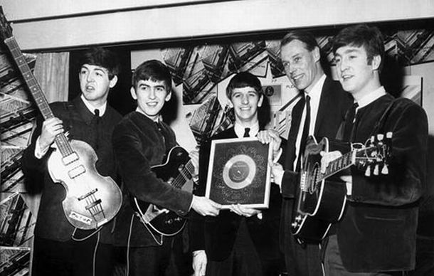 April 1963: Beatles with George Martin at EMI House in central London receiving their first silver disc for sales of more than 250,000 copies of “Please, Please Me.” Click for 2017 book, “Maximum Volume: The Life of Beatles Producer George Martin, The Early Years, 1926–1966”.