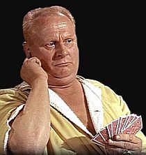Auric Goldfinger listening to tips on his cheating hotline from balcony overlooking card game in his first unhappy encounter w/James Bond. 