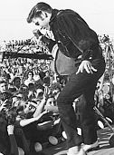 Elvis Preley in 1956, performing before a large crowd in his hometown of Tupelo, Mississippi.