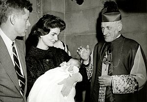 November 27, 1957: JFK and Jacqueline at the christening of their daughter, Caroline, with then Archbishop Richard Cushing of Boston.