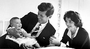 March 1958: Senator Kennedy holding baby daughter, Caroline, with Jackie at his side, photographed in their Georgetown /Wash., DC home by Life magazine photo-grapher Ed Clark for magazine issue below.