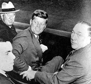 Oct 1959: JFK courting Chicago Mayor Richard J. Daley at Comiskey Park during Dodgers-White Sox World Series game, along with  baseball commissioner  "Happy" Chandler (with hat) and Daley’s son, Richard M., then a state senator, in foreground. Chicago Sun-Times.