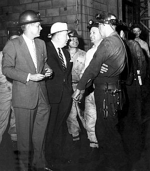 May 9, 1959: Senator Kennedy (left) with Senator Jennings Randolph (white hat) and coal miners, U. S. Steel Cleaning Plant, Gary, WV. WV state archives.