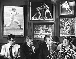 June 1969: Sportscasters Pat Summerall & Frank Gifford (c), listen as Joe Namath (r) announces his retirement from pro football at his Bachelors III nightclub due to dispute with the NFL over his ownership of the club. On July 18, he announced he sold the bar and was coming back out of retirement. Click photo to visit Namath story.
