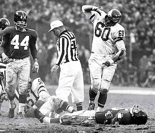 Iconic Photo. Chuck Bednarik, No. 60, standing over NY Giants running back, Frank Gifford after famous tackle, 20 Nov 1960.  Photo/ John G. Zimmerman / Sports Illustrated.