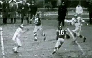 Frank Gifford, No. 16, has just taken a few steps after catching a pass over the middle, trying to avoid a downfield tackler, as No. 60, Chuck Bednarik, takes a bead on him.