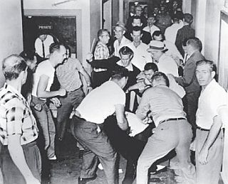 Part of the attacking mob with KKK members at Birmingham, AL, as black bystander George Webb is beaten by several men in the foreground. Photo, Tommy Langston.