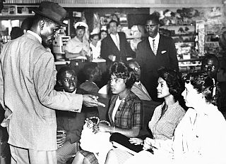May 18,1961: Rev. Fred Shuttlesworth, left, talks with several Freedom Riders waiting in the Birmingham bus station to go to Montgomery. AP photo. 